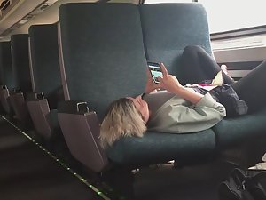 Peeping on teen girl in comfortable pose in train
