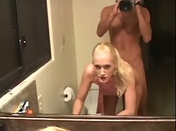 In the ass in front of a mirror