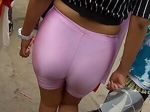 Sexy thong is visible through pink shorts in a crowded place