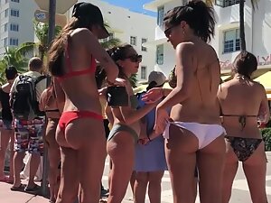 Two girls with fine butts are watching the parade