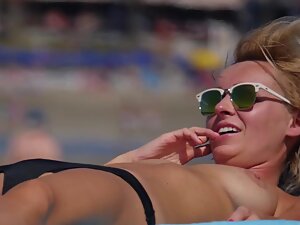 Cute topless girl smiles while she talks on the phone