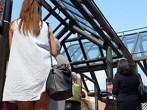 Upskirt look while she stands at bus station