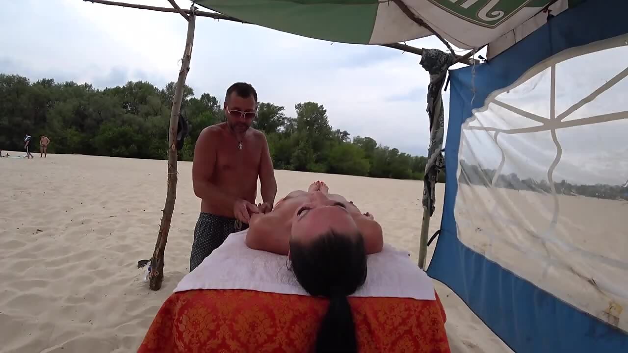 Hottest girl gets naked massage on beach