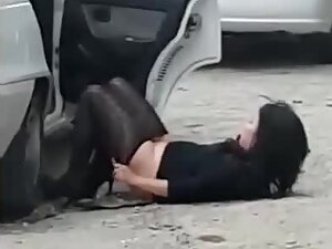 Sexy girl falls down while she is pissing by the car