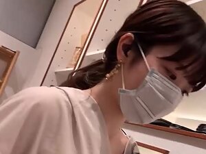 Downblouse look of helpful asian salesgirl