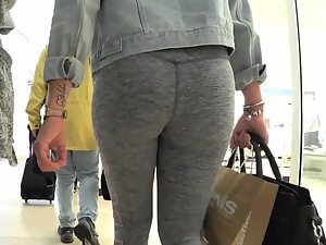 Her ass fills up grey leggings in a lovely way