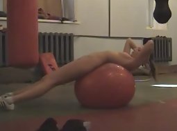Nudist girl exercising in the gym