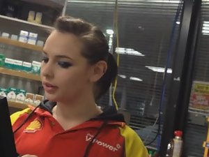 Adorable girl works at gas station