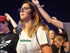 Pretty hipster girl at a concert without a bra