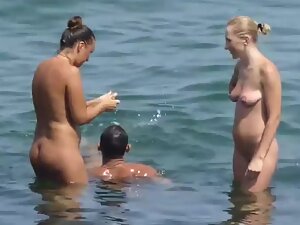 Swimming around nudist women in ocean