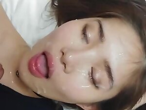 Asian girl's cute face ends up covered with cum