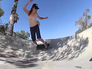 Skater girl skateboards in topless