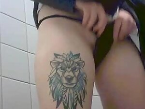 Spying on punk girl with lion tattoo taking a piss