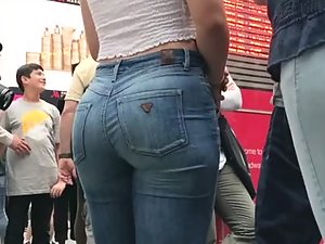 Curly haired girl with nicely filled jeans