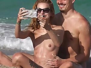 Enchanting tattooed nudist girl on the beach
