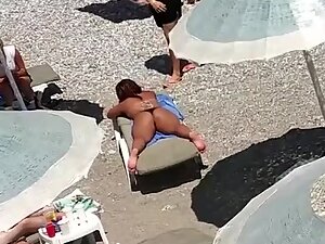 Enjoying a tanned ass from a room that overlooks the beach