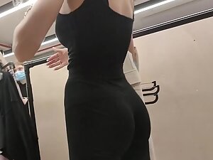 Black pants show off her perky ass and thong outline