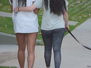 Lesbian girls hug and walk their dog