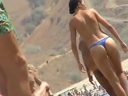 Topless babe in a thong bikini