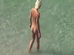 Sexy woman gets naked on a beach