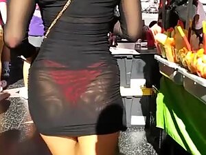 Sunlight makes her red thong show