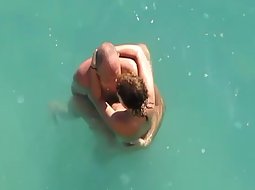 Couple trying sex under the water
