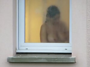 Watching incredible tits through her bathroom window