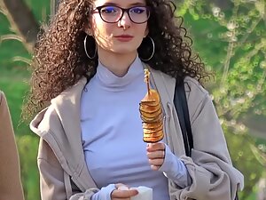 Curly girl's nipple and piercing visible through clothes