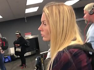Sexy blonde is frustrated while waiting for luggage