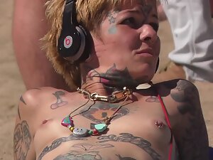 One of a kind topless punk girl on the beach