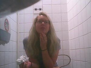 Cute geeky blonde caught peeing in public toilet