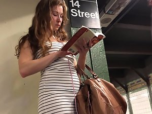 Curvy bookworm in a tight dress at subway