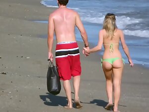 Tall guy walks with sexy shorty on the beach