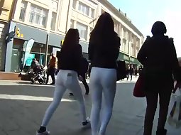 Teen girls both wear white pants