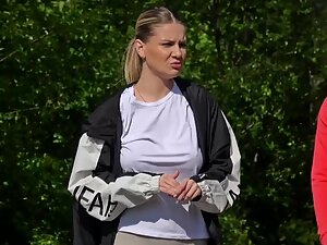 Sporty girl isn't wearing a bra while she walks the dog