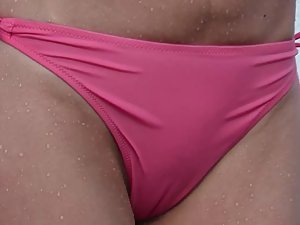 Milf with ripe butt and nice cameltoe in pink bikini