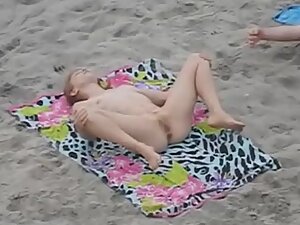 Nudist girl spreads herself wide on the beach