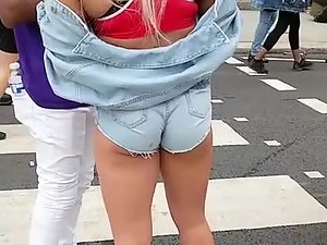 Slutty blonde with clenched ass in cutoff shorts