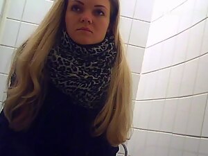 Spying on adorable girl peeing in public toilet