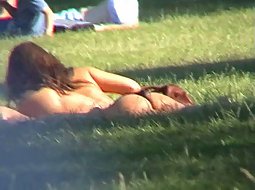frisky girls tanning in the park