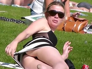 Peeping on blonde's ass despite her attempts to cover it